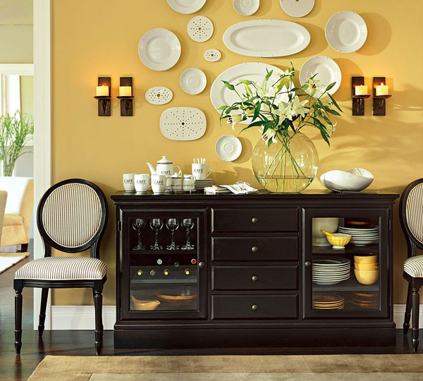 Кераміка ручної роботи Керамічний посуд ручної роботи: тарілки з орнаментом та чашки на кухонній полиці.