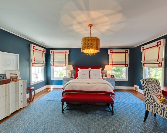 Червона спальня з великим ліжком та м'яким освітленням, що створює романтичну атмосферу