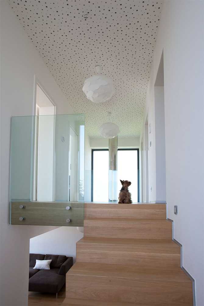 Світло над вогнем Велике вікно над каміном у сучасній вітальні, що забезпечує природне освітлення.