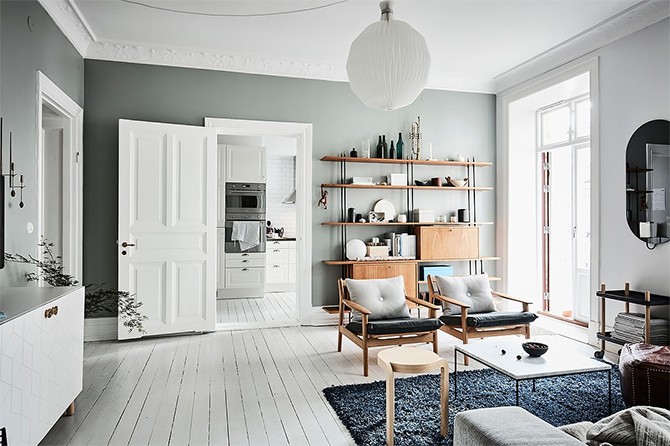Вітальня-кухня: єдиний стиль Перехід з вітальні в кухню в скандинавському стилі маленької квартири